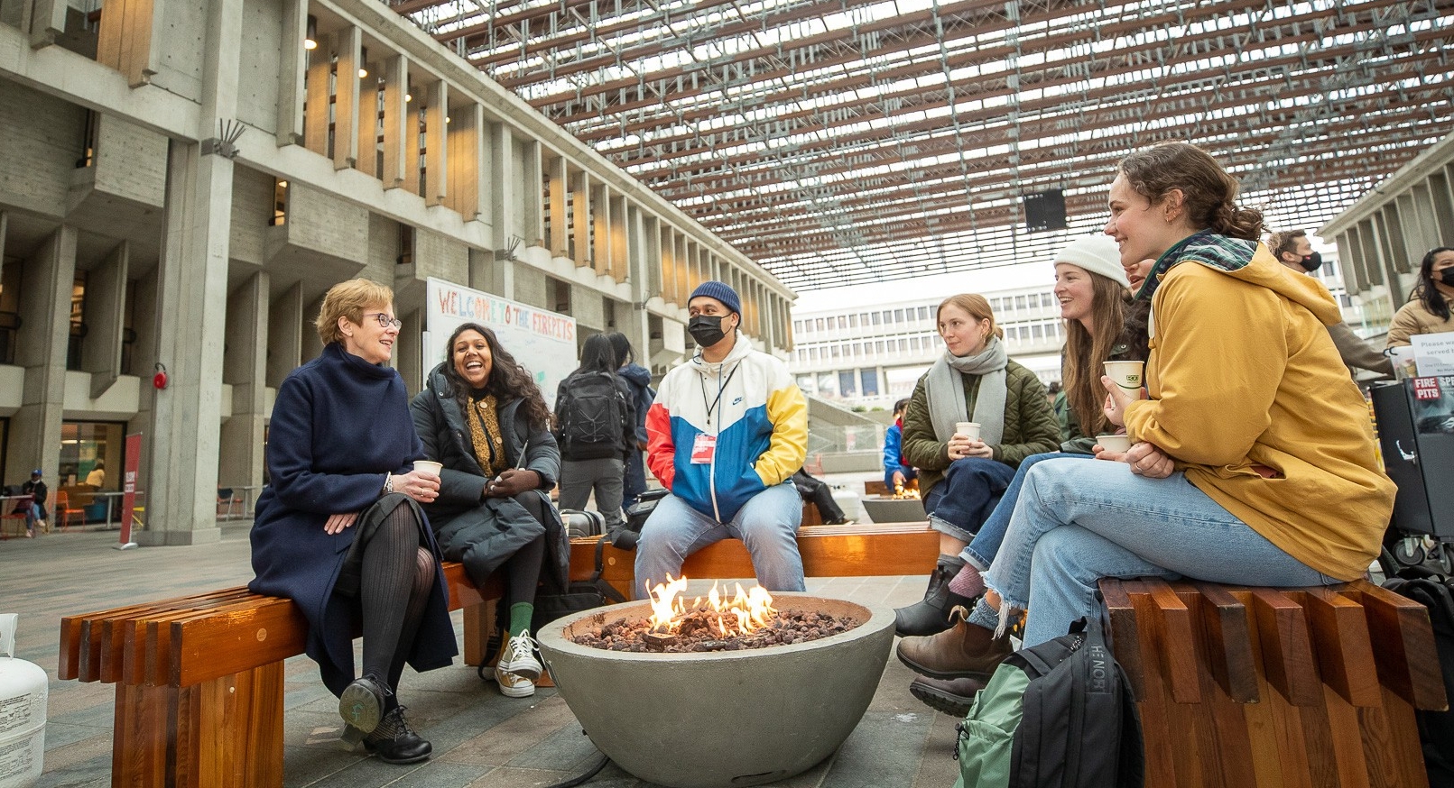 Joy sitting with students